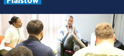 The image shows a group of people seated in a room, with some facing away from the camera and others facing towards it. The text "People Powered Plaistow" is prominently displayed at the top of the image. There is also a logo for "Newham London" in the upper right corner.