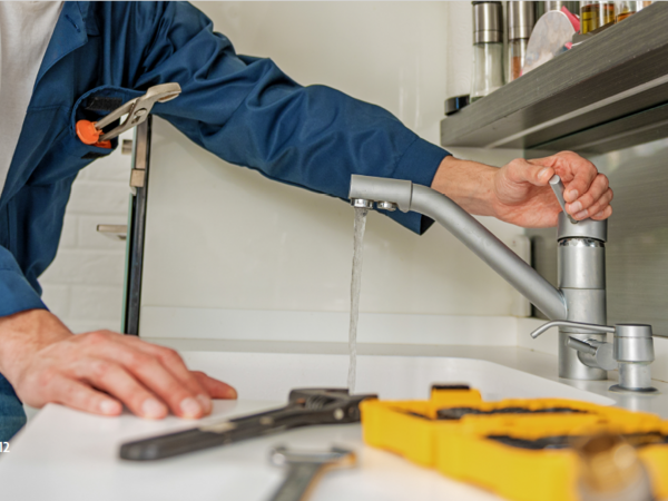 Plumber repairing tap
