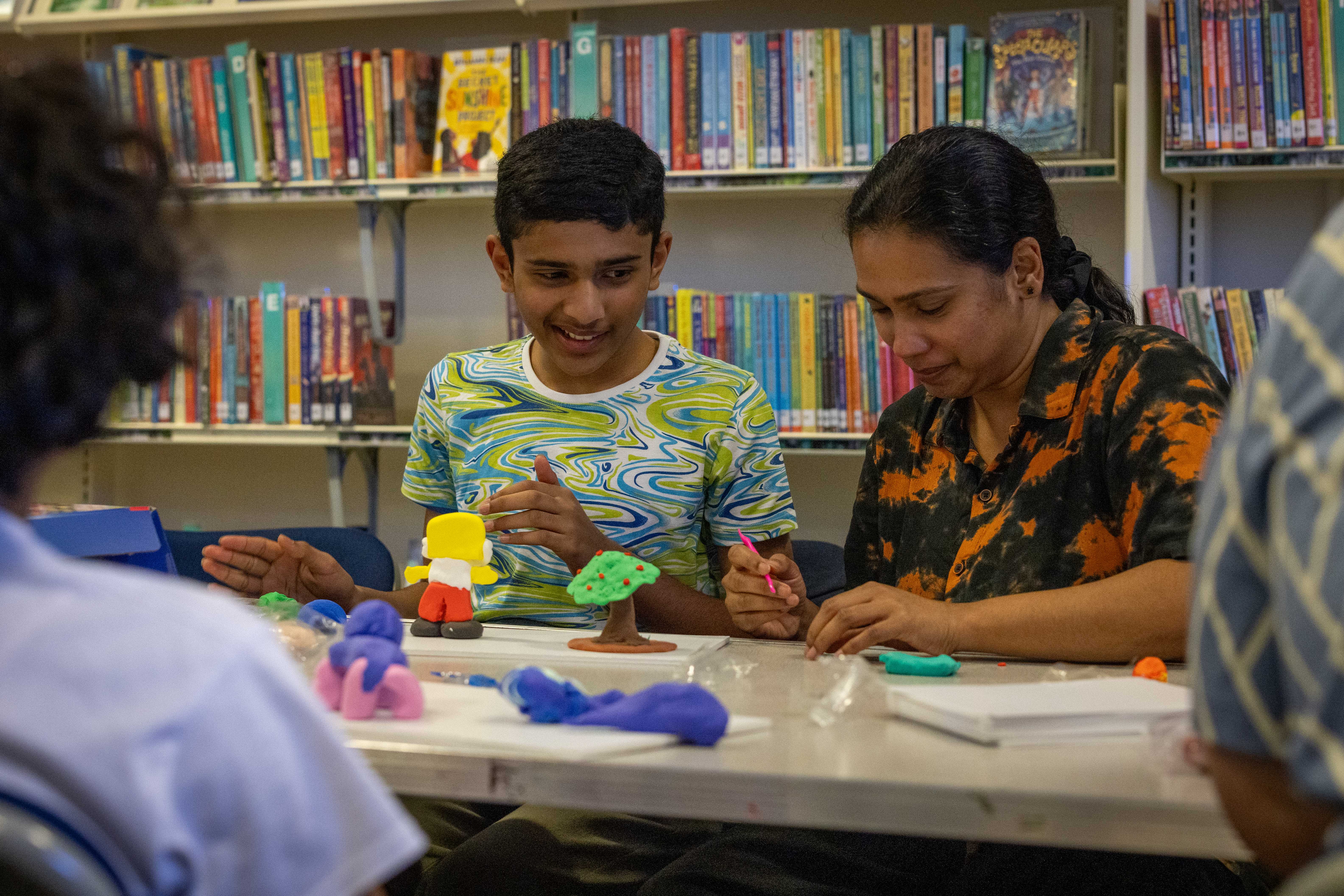 Mother and son making clay models together
