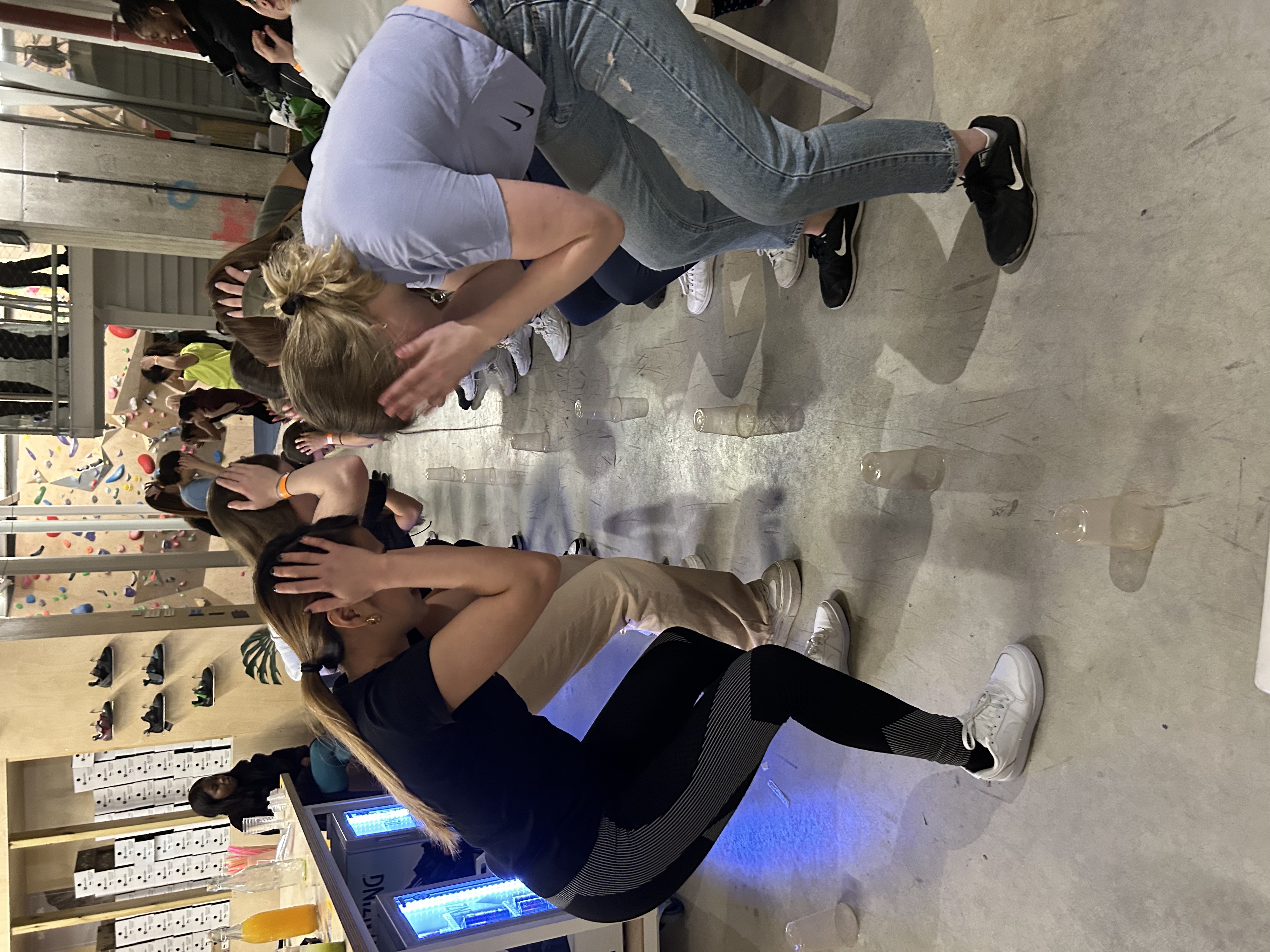 Women participating in group activity during previous social event held at rise&climb.