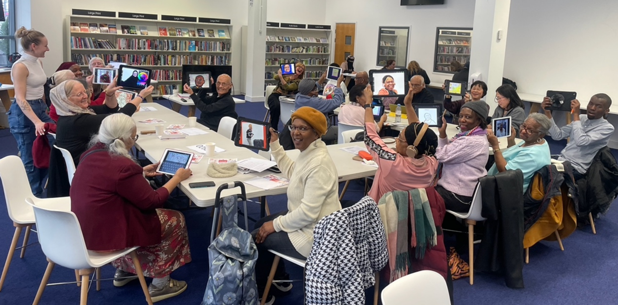Group of people taking photos on tablets at Stratford Library