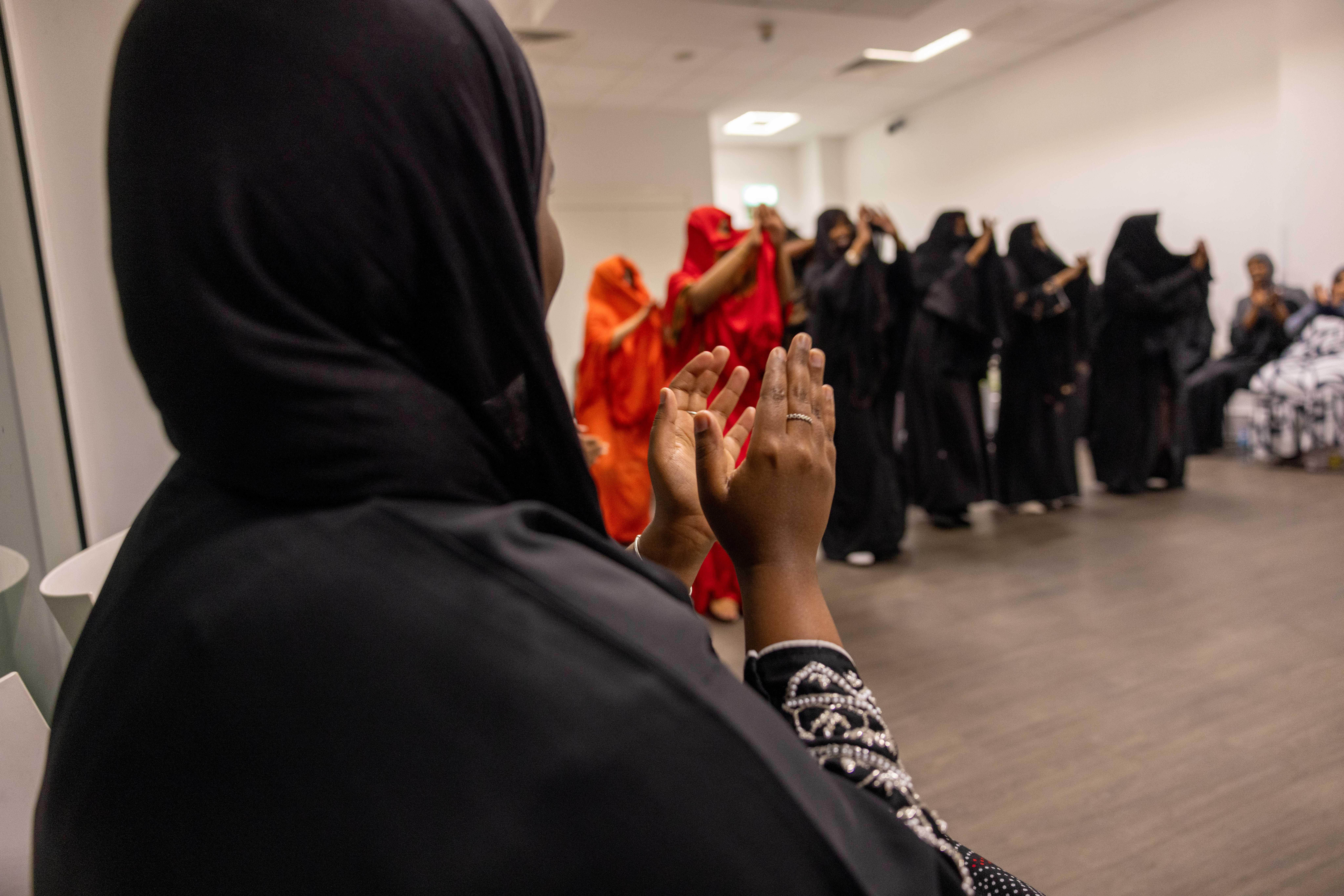 Group of people dancing with lady clapping