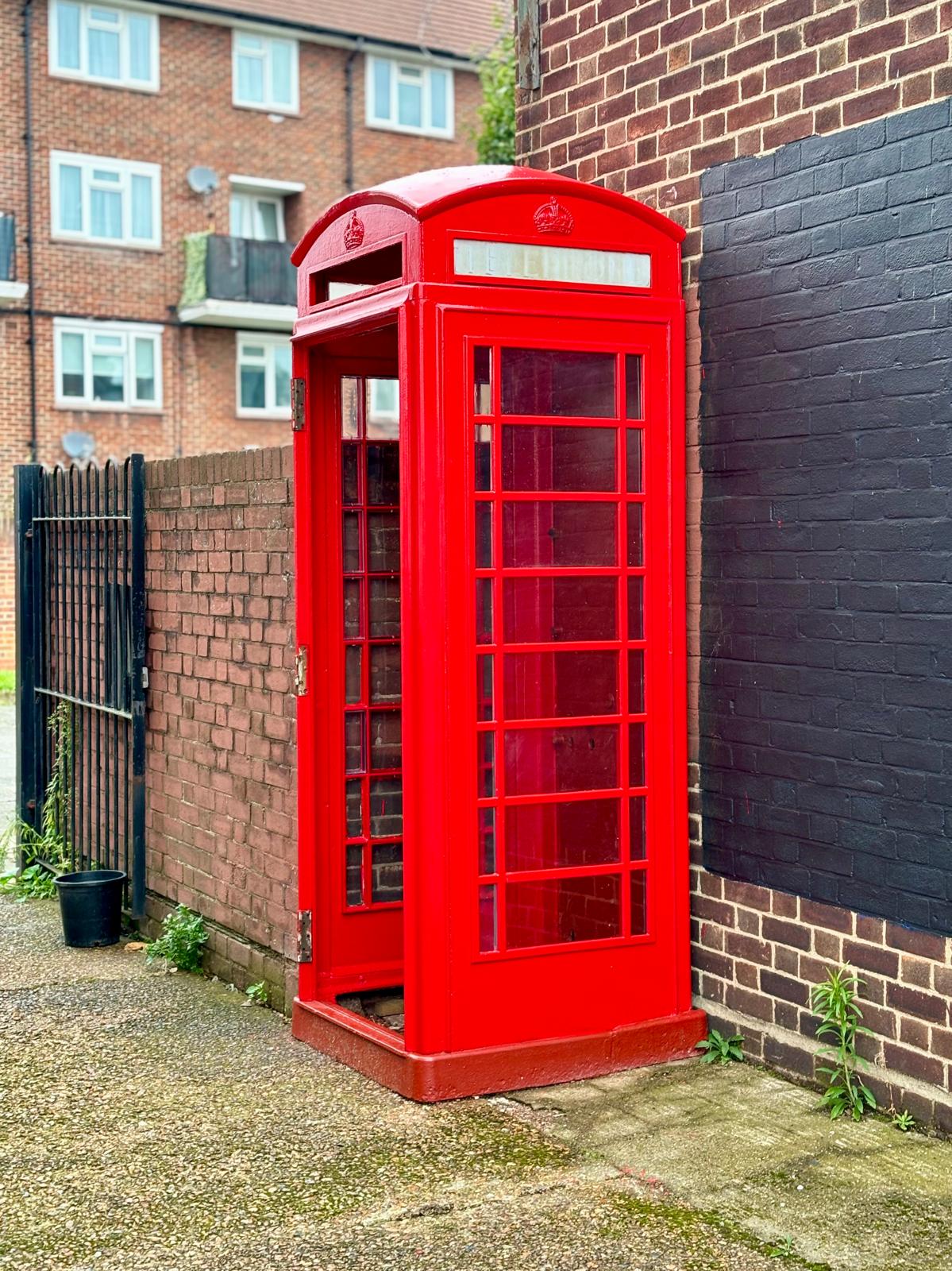 the phone box, now painted red with new glass installed