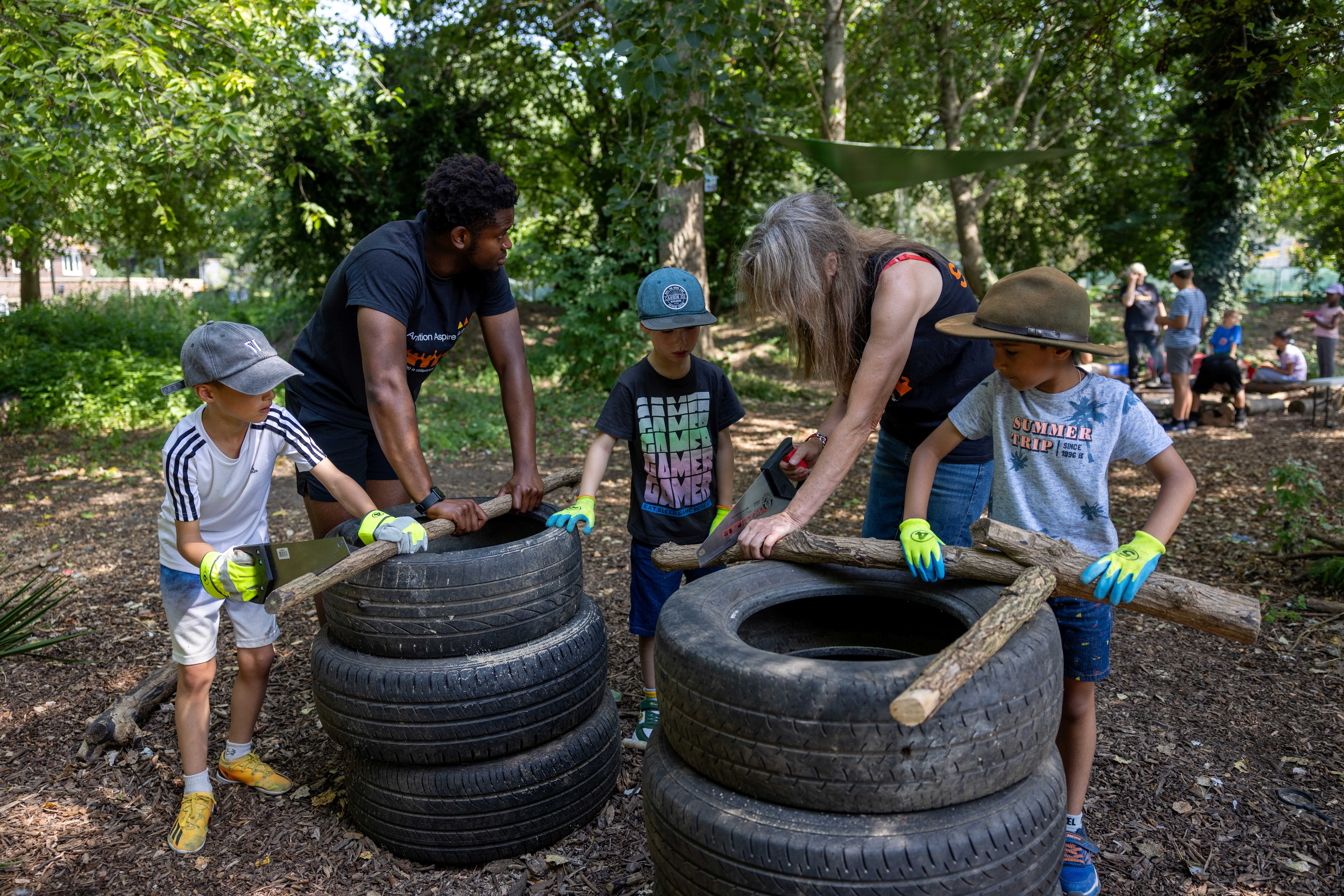Group leaders and children sawing branches